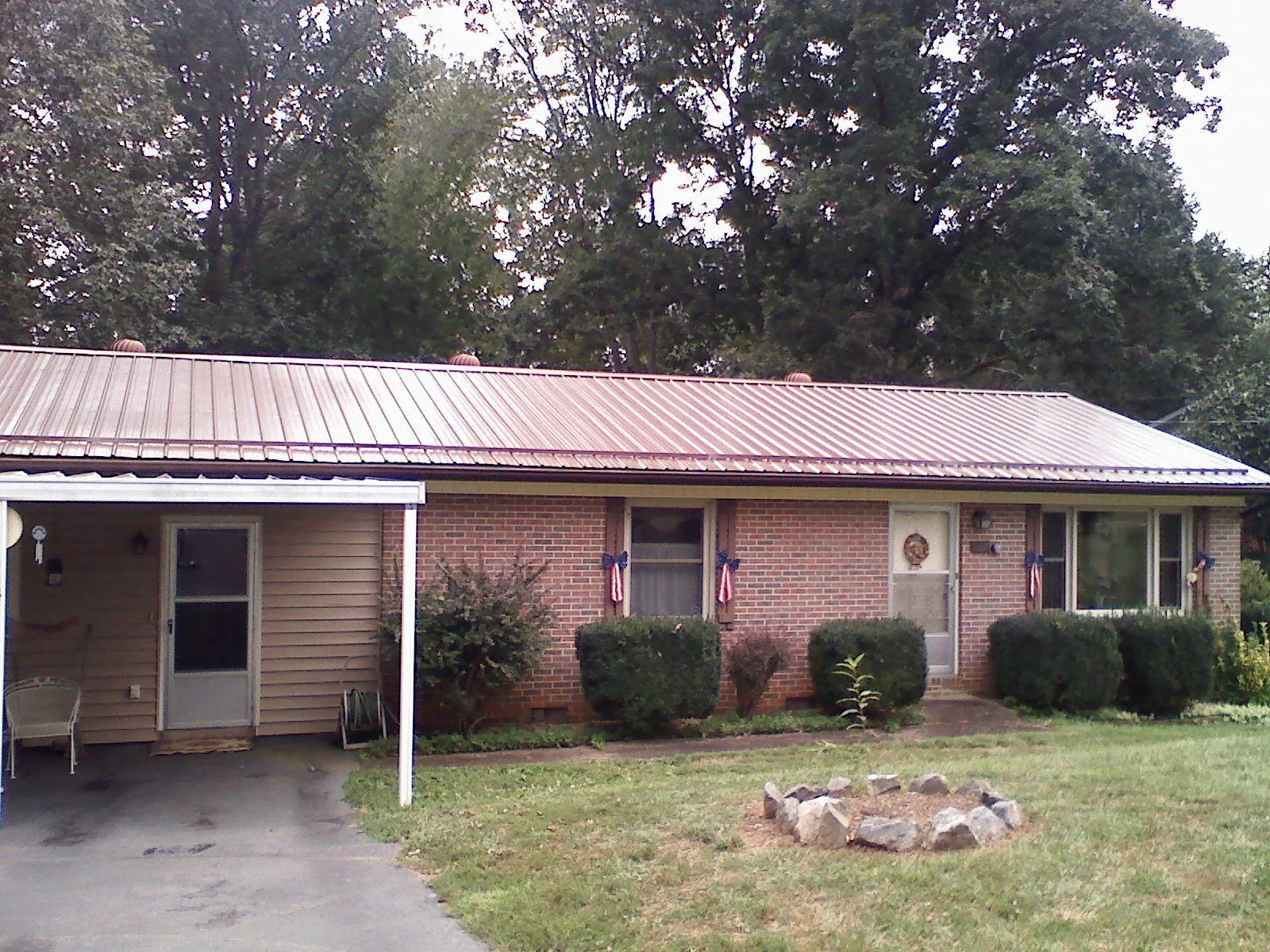 Bronze metal roof and carport on a brick ranch home — Roof Repair work by our crew in East Saint Louis