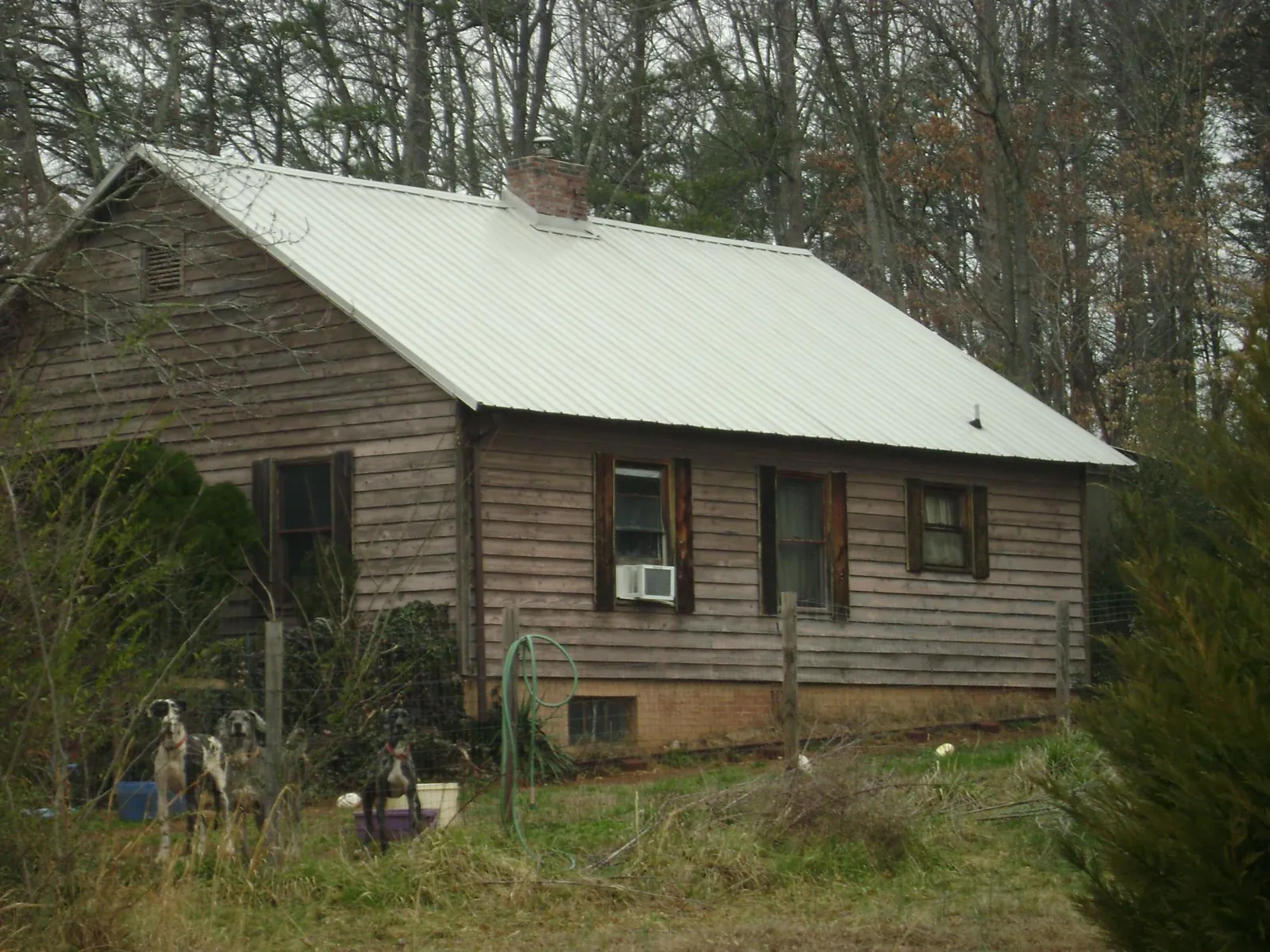 White metal roof on an old wood sided farmhouse, from a Metal Roof Installation job in East Saint Louis